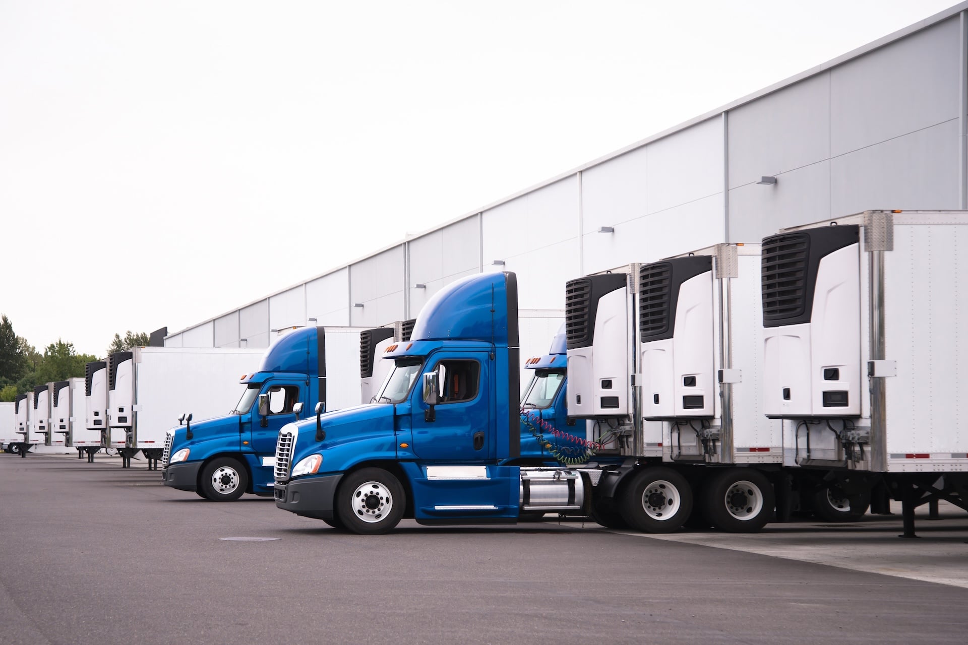 Everflow branded semi-trucks parked at warehouse loading docks for product transportation.