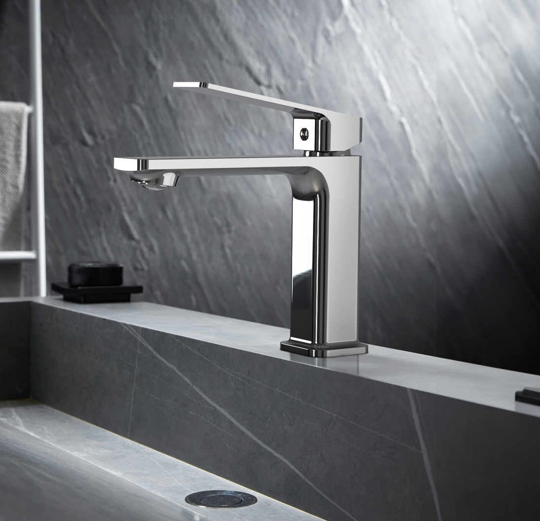 Modern chrome single-handle bathroom faucet over a gray stone sink.