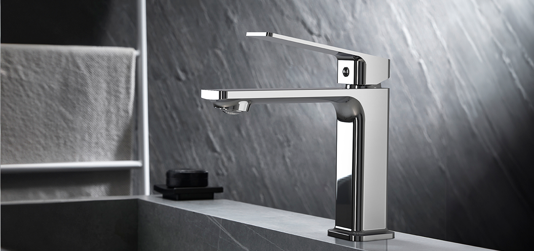 Modern chrome bathroom faucet installed over a contemporary stone sink.