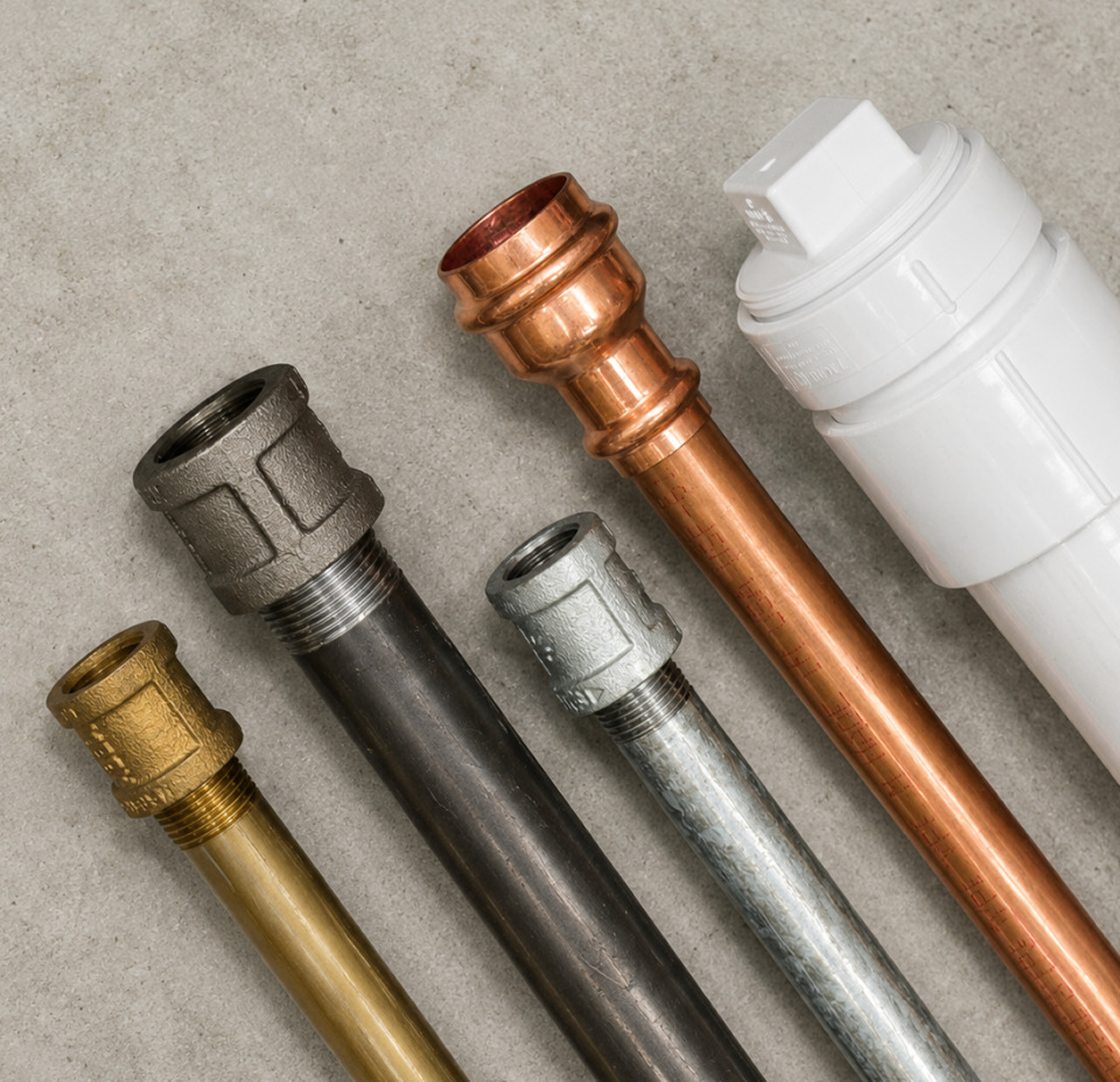 Assortment of Everflow metal and PVC pipe nipples in multiple materials.