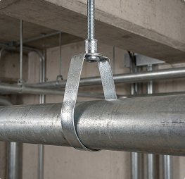 Close-up of threaded metal pipe fittings and nipples used in plumbing systems.
