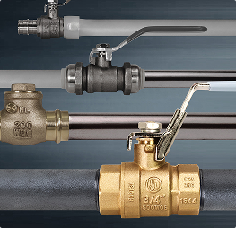 Brass and metal ball valves installed on piping with lever handles.